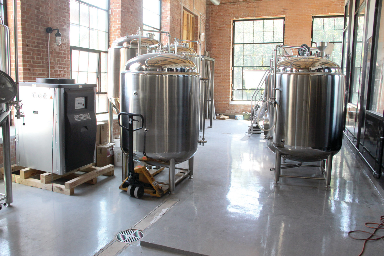 SOMETHING’S BREWIN’: Apponaug Brewing Company is raring to go, with their first brewing location already set up in a commercial space at the Mills. These fermentation tanks here can produce 310 gallons of beer. They hope to open before Labor Day.